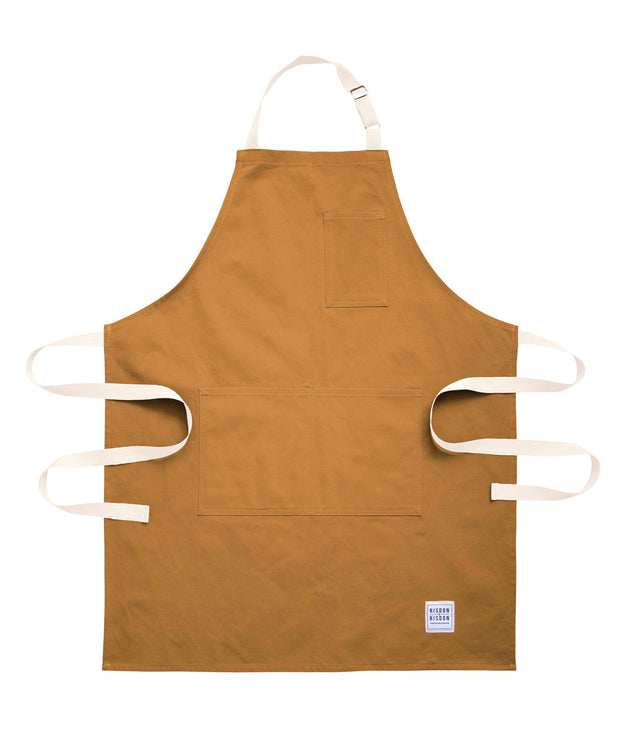 Handcrafted, tan canvas apron with white straps; made in Britain.