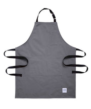 Handcrafted grey canvas apron with black straps: made in Britain.