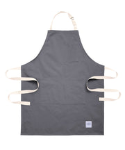 Handcrafted grey canvas apron with white straps: made in Britain.