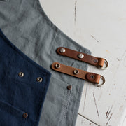 Handcrafted, canvas aprons that are made in Britain with pockets and leather trim and straps.