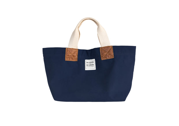 A Navy blue handcrafted leather and canvas mini market bag