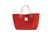 A red handcrafted leather and canvas mini market bag