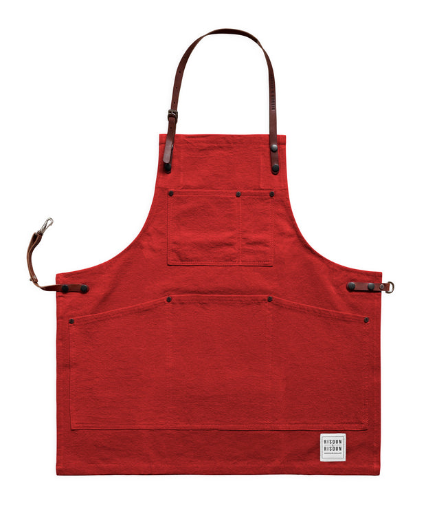 Children's handcrafted red canvas apron with removable leather straps: made in Britain.