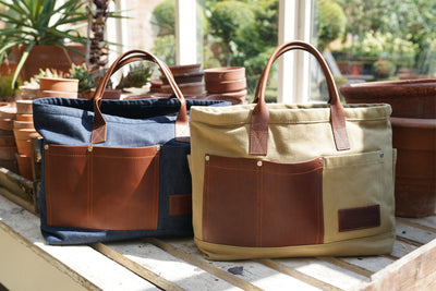 A handmade canvas gardeners bag with leather handles and pockets. And another with denim instead of canvas