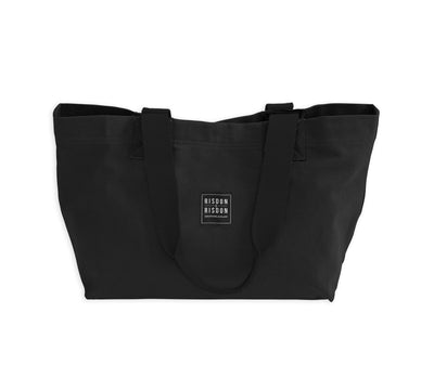A leather and canvas handcrafted black tote travel bag.