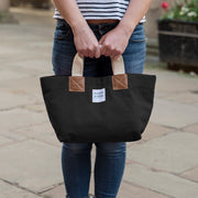 A black handcrafted leather and canvas mini market bag