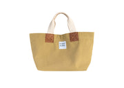 A trade brown handcrafted leather and canvas mini market bag