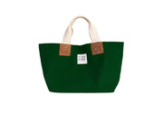 A green handcrafted leather and canvas mini market bag