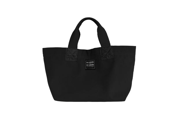 A leather and canvas handcrafted small black tote travel bag.