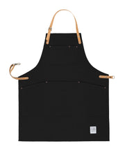 Handcrafted, black canvas apron; made in Britain with pockets and removable, cork straps.
