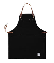 Handcrafted, black canvas apron; made in Britain with pockets and removable leather straps.