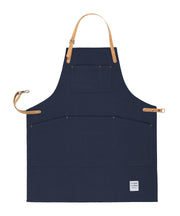 Handcrafted, navy blue canvas apron; made in Britain with pockets and removable, cork straps.