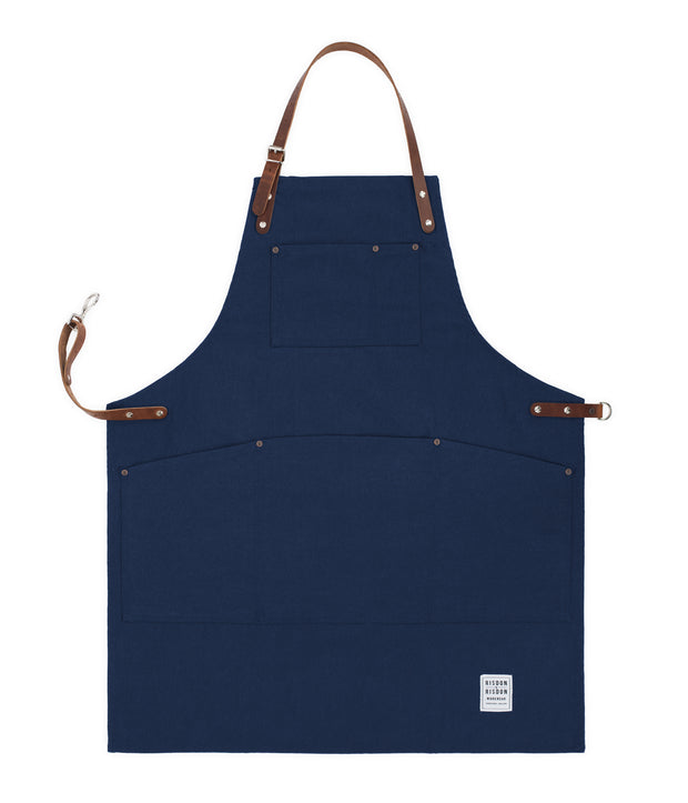 Handcrafted, navy blue canvas apron; made in Britain with pockets and removable leather straps.