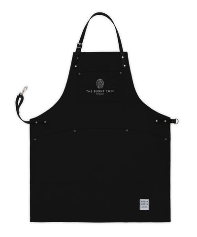 Handcrafted, black canvas apron; made in Britain with pockets and removable, leather straps.