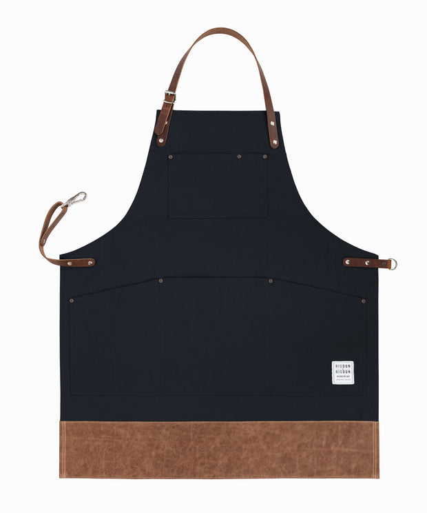 Handcrafted, black canvas apron; made in Britain with pockets and leather trim and straps.