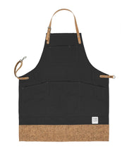 Handcrafted, black canvas apron; made in Britain with pockets and cork trim and straps.