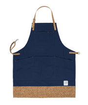 Handcrafted, navy blue canvas apron; made in Britain with pockets and cork trim and straps.