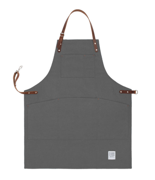 Handcrafted, heritage grey canvas apron; made in Britain with pockets and removable leather straps.