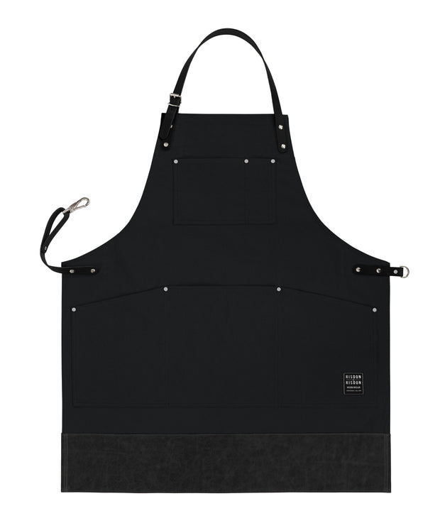 Handcrafted, black canvas apron; made in Britain with removable straps and leather trim.