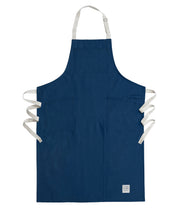 Handcrafted, blue canvas apron with white straps; made in Britain.
