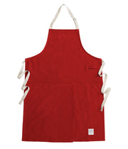 Handcrafted, red canvas apron with white straps; made in Britain.