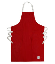 Handcrafted, red canvas apron with white straps; made in Britain.