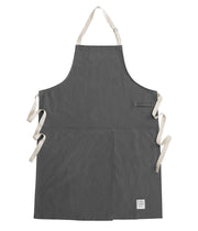 Handcrafted, grey canvas apron with white straps; made in Britain.