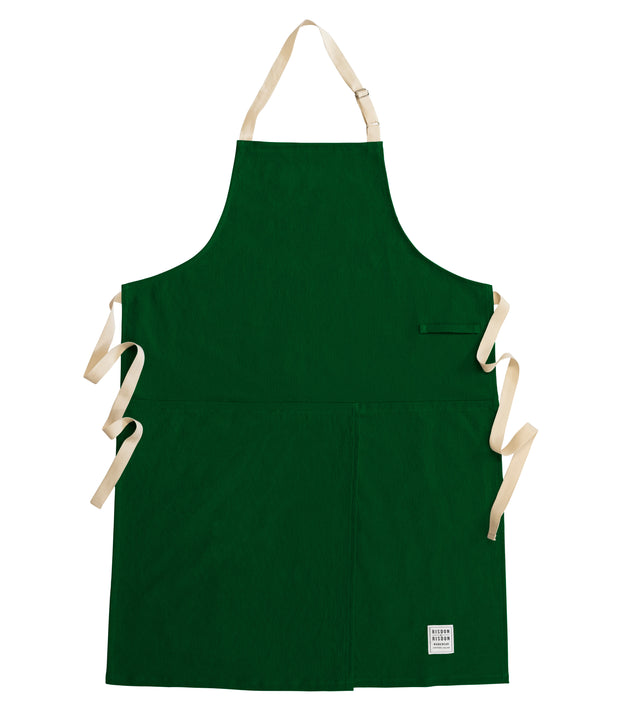 Handcrafted, green canvas apron with white straps; made in Britain.
