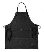 Handcrafted, black denim apron; made in Britain with pockets and removable, black leather straps.