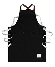Children's handcrafted black canvas apron with removable leather straps: made in Britain.
