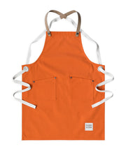 Children's handcrafted burnt orange canvas apron with removable cork straps: made in Britain.