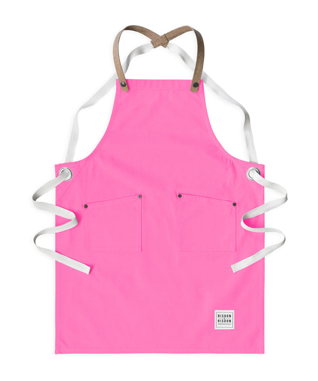Children's handcrafted candy pink canvas apron with removable cork straps: made in Britain.