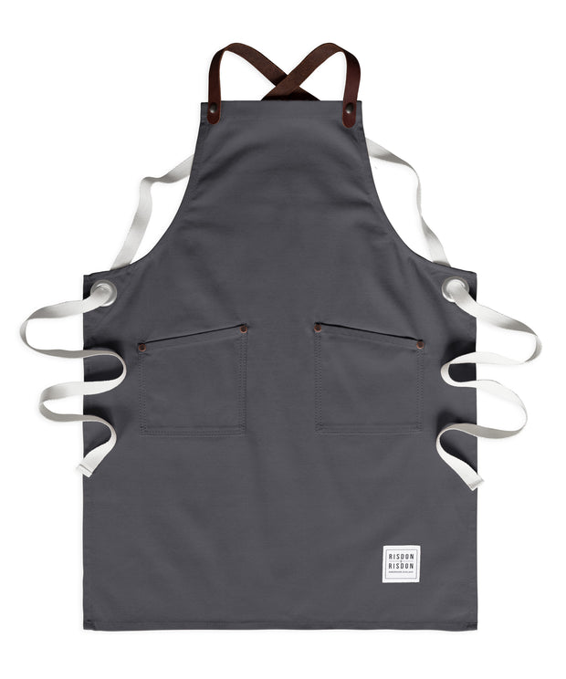 Children's handcrafted charcoal grey canvas apron with removable leather straps: made in Britain.