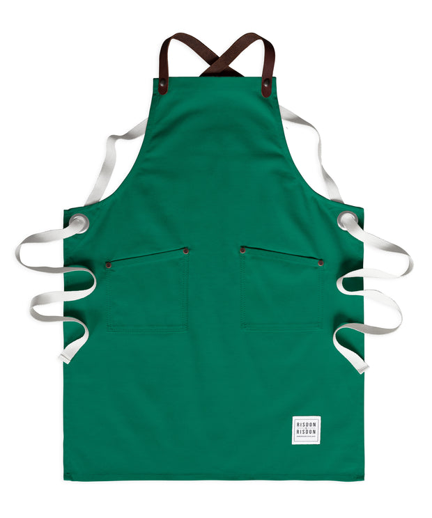Children's handcrafted forest green canvas apron with removable leather straps: made in Britain.