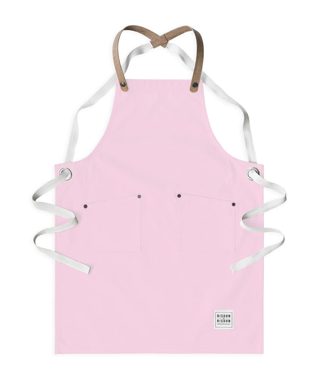 Children's handcrafted pink canvas apron with removable cork straps: made in Britain.