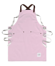 Children's handcrafted pink canvas apron with removable leather straps: made in Britain.