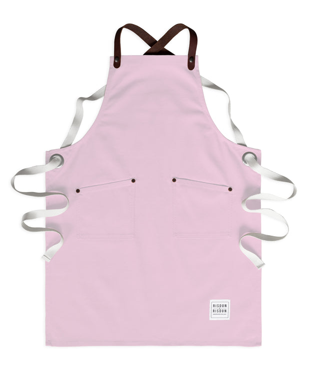 Children's handcrafted pink canvas apron with removable leather straps: made in Britain.