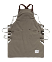 Children's handcrafted taupe canvas apron with removable leather straps: made in Britain.