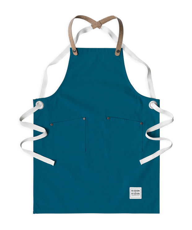 Children's handcrafted teal canvas apron with removable cork straps: made in Britain.