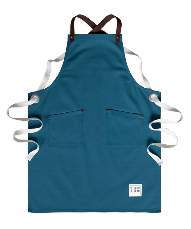 Children's handcrafted teal canvas apron with removable leather straps: made in Britain.