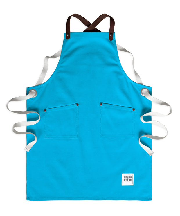 Children's handcrafted turquoise canvas apron with removable leather straps: made in Britain.