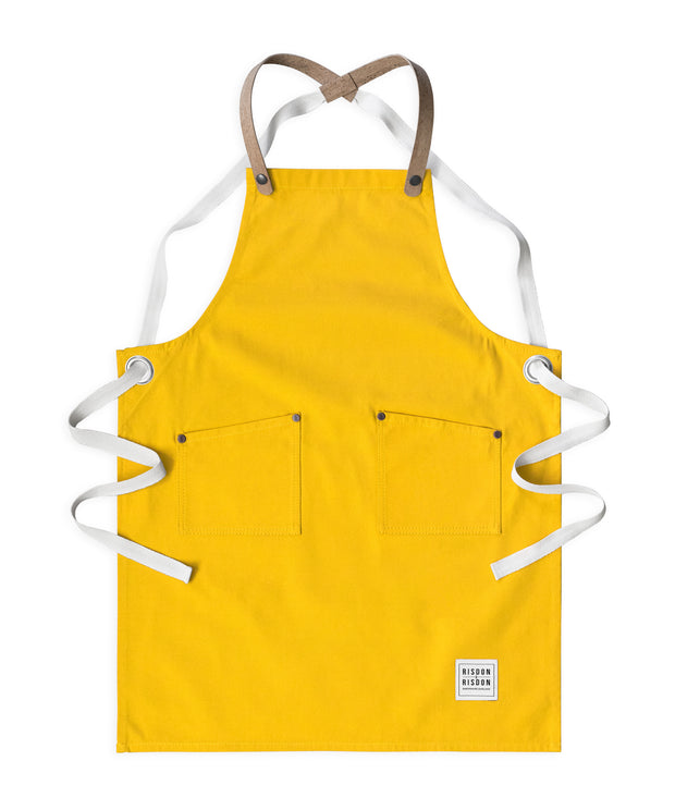 Children's handcrafted yellow canvas apron with removable cork straps: made in Britain.