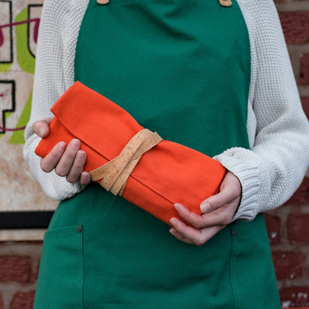 A handcrafted orange Leather and Canvas artist roll