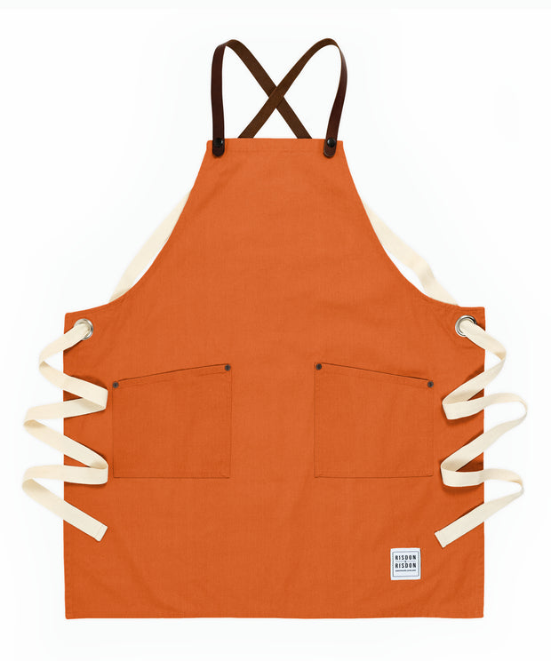 A handcrafted canvas apron with removable leather straps