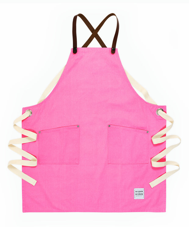 A handcrafted canvas apron with removable leather straps