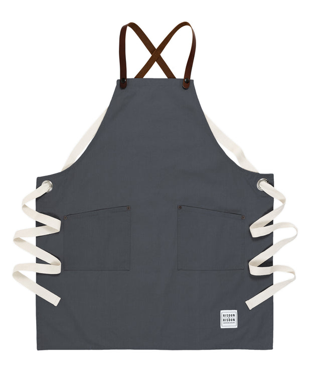 A handcrafted canvas apron with removable leather straps