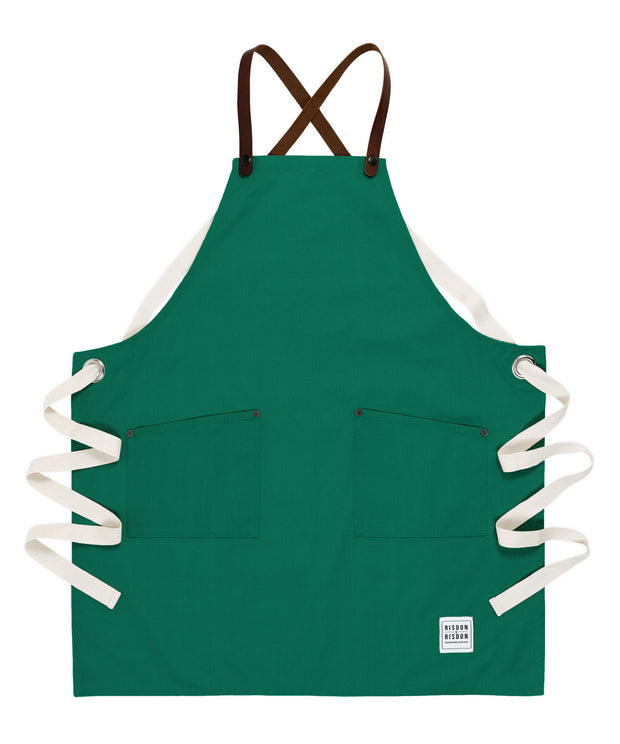 A handcrafted canvas apron with removable leather straps
