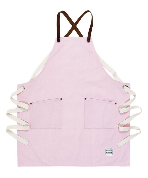 A handcrafted canvas apron with removable leather straps