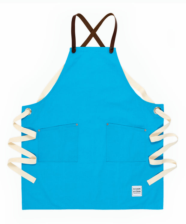 A handcrafted canvas apron with removable leather straps
