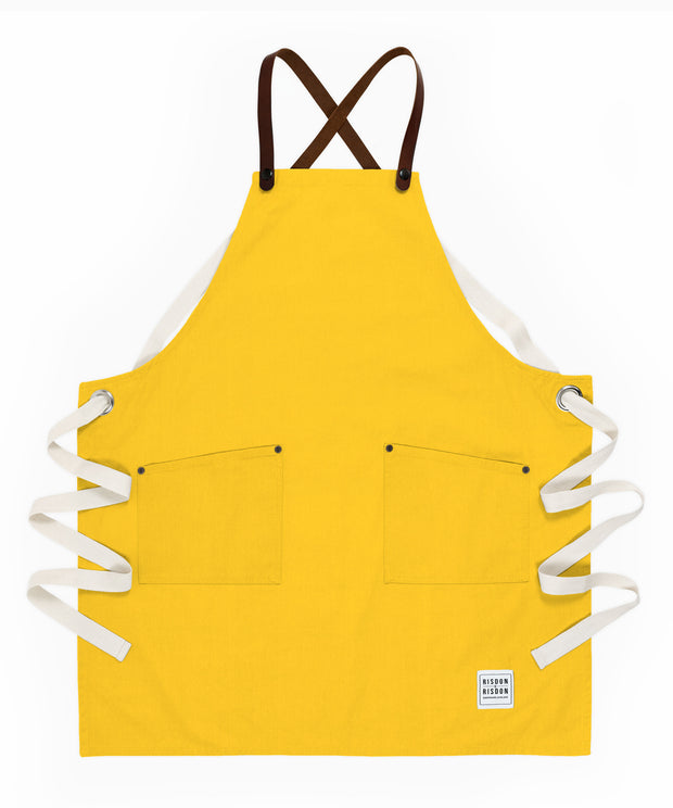 A handcrafted canvas apron with removable leather straps
